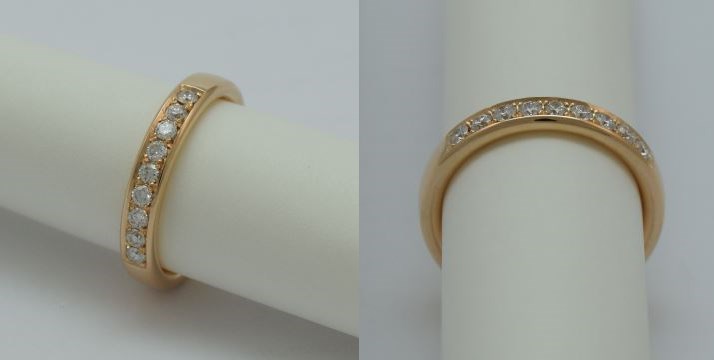 A yellow golden ring with a single row of pavé stones.
