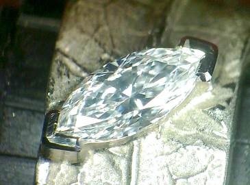 A marquise shape diamond held by two V-shaped prongs
